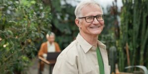 Senior With Glasses Smiling in Garden 