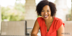 Female model in red for All-on-X Dental Implants