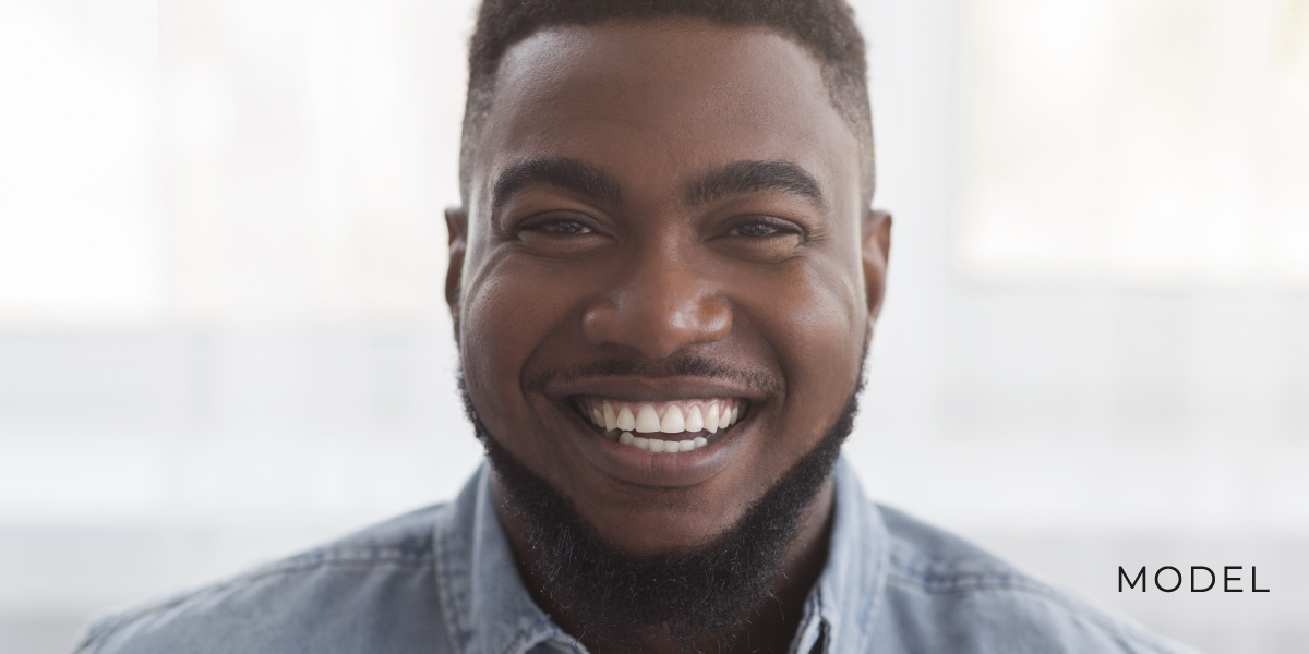 This smiling model demonstrates the potential results of dental implants.